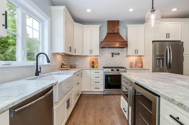 131 Colts Way, Attleboro, MA 02703 - kitchen with stainless steel appliances, custom range hood, wine cooler, healthy amount of natural light, and recessed lighting