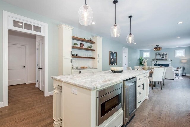 131 Colts Way, Attleboro, MA 02703 - kitchen featuring stainless steel microwave, white cabinetry, beverage cooler, open shelves, and recessed lighting