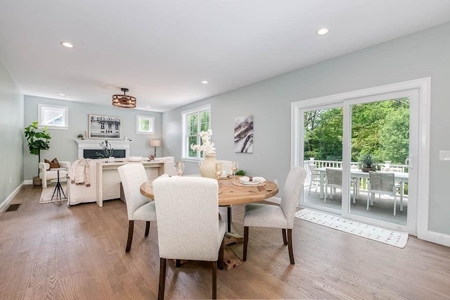 131 Colts Way, Attleboro, MA 02703 - dining area with wood finished floors, baseboards, healthy amount of natural light, recessed lighting, and a fireplace