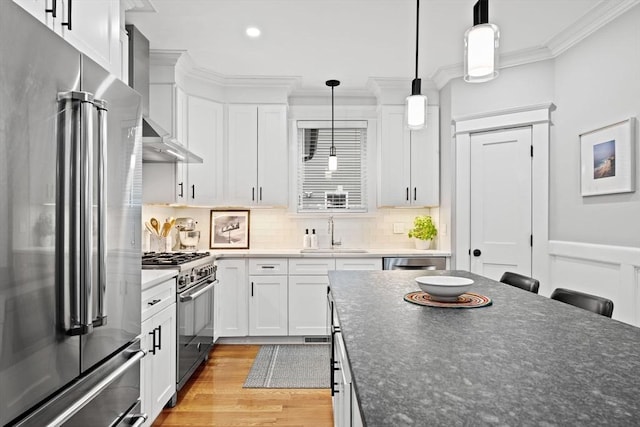 31 Henderson St Unit 1, Arlington, MA 02474 - kitchen featuring stainless steel appliances, a sink, ornamental molding, light wood finished floors, and white cabinets