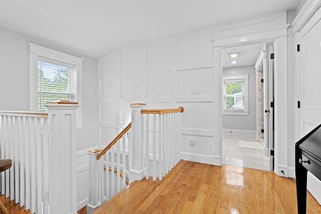 31 Henderson St Unit 1, Arlington, MA 02474 - hall with an upstairs landing, a decorative wall, plenty of natural light, and light wood finished floors