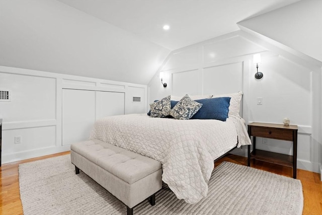 31 Henderson St Unit 1, Arlington, MA 02474 - bedroom featuring a decorative wall, wood finished floors, and vaulted ceiling