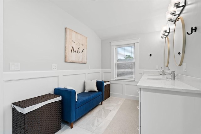 31 Henderson St Unit 1, Arlington, MA 02474 - full bath featuring lofted ceiling, double vanity, a wainscoted wall, and a decorative wall