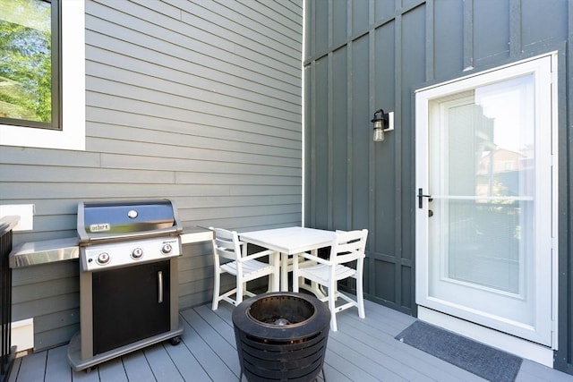 31 Henderson St Unit 1, Arlington, MA 02474 - wooden deck featuring outdoor dining area, a grill, and a fire pit