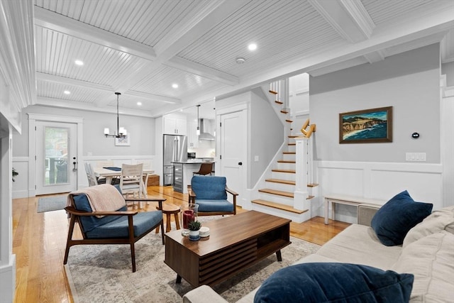 31 Henderson St Unit 1, Arlington, MA 02474 - living area featuring beamed ceiling, a decorative wall, light wood-style floors, stairway, and coffered ceiling