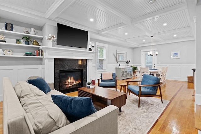 31 Henderson St Unit 1, Arlington, MA 02474 - living area with light wood-type flooring, a decorative wall, beam ceiling, coffered ceiling, and a fireplace