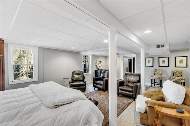 carpeted bedroom featuring recessed lighting, a drop ceiling, visible vents, and baseboards