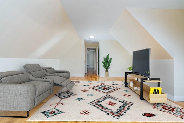 living room with light hardwood / wood-style floors and lofted ceiling