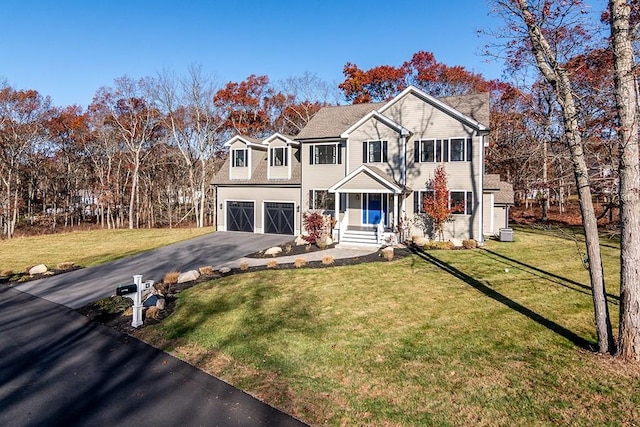 front facade featuring a garage and a front lawn