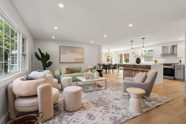 living room with recessed lighting, plenty of natural light, and light wood finished floors