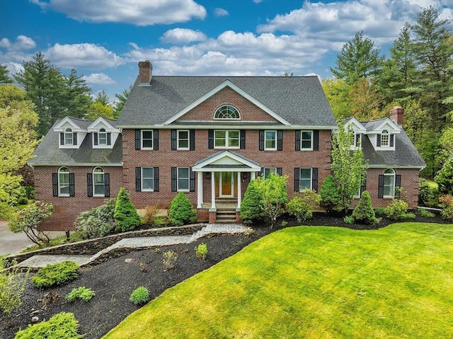14 Preservation Way, Westford, MA 01886 - colonial home with a chimney, brick siding, a front yard, and a shingled roof
