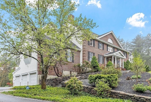 14 Preservation Way, Westford, MA 01886 - view of front of property featuring a garage, brick siding, and a chimney