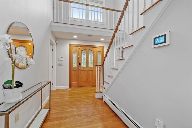 14 Preservation Way, Westford, MA 01886 - entryway featuring stairs, light wood-style flooring, a towering ceiling, baseboards, and baseboard heating