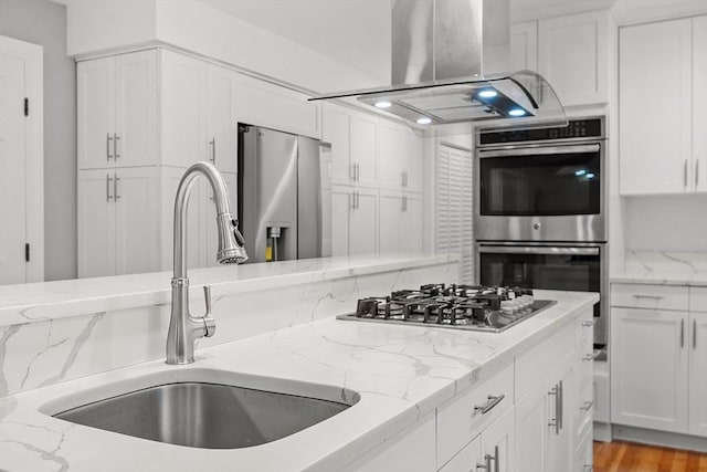 14 Preservation Way, Westford, MA 01886 - kitchen featuring a sink, island exhaust hood, appliances with stainless steel finishes, and white cabinets