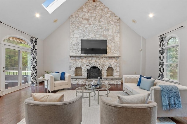 14 Preservation Way, Westford, MA 01886 - living room featuring high vaulted ceiling, wood finished floors, a skylight, plenty of natural light, and a fireplace