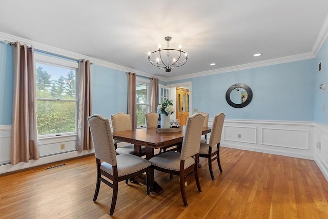14 Preservation Way, Westford, MA 01886 - dining space featuring a chandelier, light wood-type flooring, crown molding, wainscoting, and a decorative wall