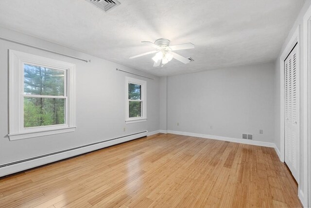 14 Preservation Way, Westford, MA 01886 - unfurnished bedroom with a baseboard radiator, light wood-style flooring, baseboards, ceiling fan, and a closet
