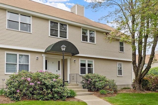 425 Main St Unit 8B, Hudson, MA 01749 - colonial home with a chimney and a front yard
