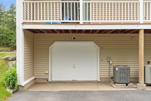 425 Main St Unit 8B, Hudson, MA 01749 - garage featuring a carport, central air condition unit, and asphalt driveway
