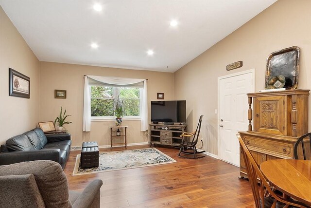 425 Main St Unit 8B, Hudson, MA 01749 - living room with wood finished floors, vaulted ceiling, baseboards, and recessed lighting
