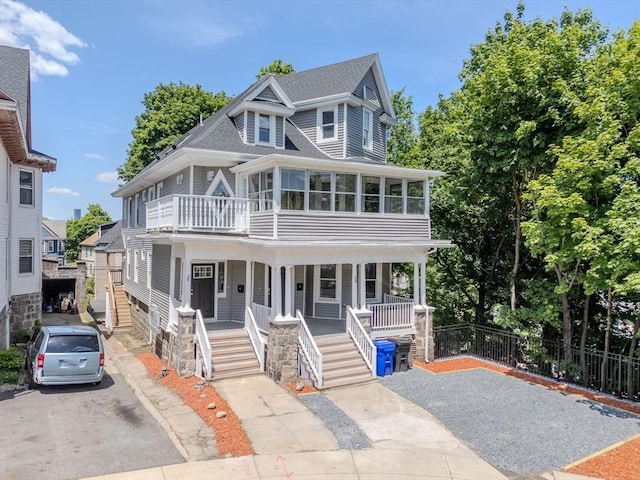 36-38 Elm Hill Park, Boston, MA 02121 - view of front of house featuring covered porch, asphalt driveway, and roof with shingles