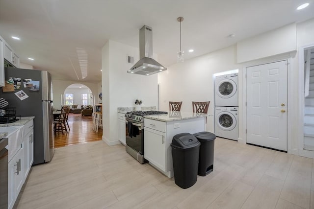 36-38 Elm Hill Park, Boston, MA 02121 - kitchen with appliances with stainless steel finishes, island range hood, stacked washer and clothes dryer, arched walkways, and white cabinetry