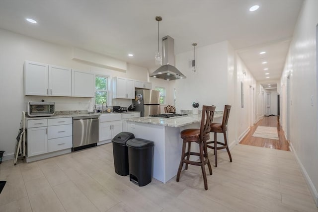 36-38 Elm Hill Park, Boston, MA 02121 - kitchen with appliances with stainless steel finishes, island range hood, light wood-type flooring, recessed lighting, and a breakfast bar area