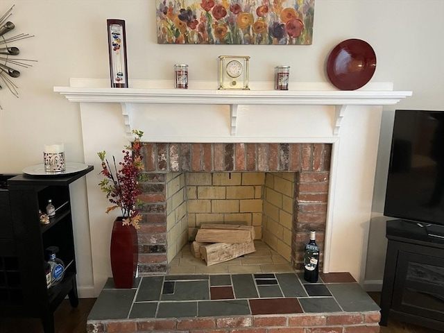 interior details featuring a brick fireplace