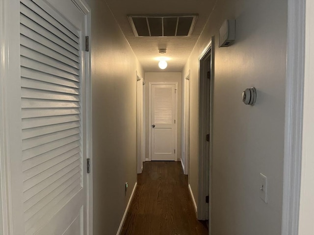 hallway with dark hardwood / wood-style flooring