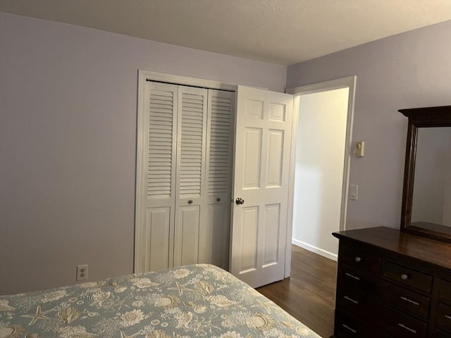 bedroom featuring a closet and dark wood-type flooring