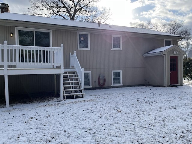 view of snow covered rear of property