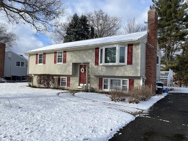 raised ranch featuring central AC unit