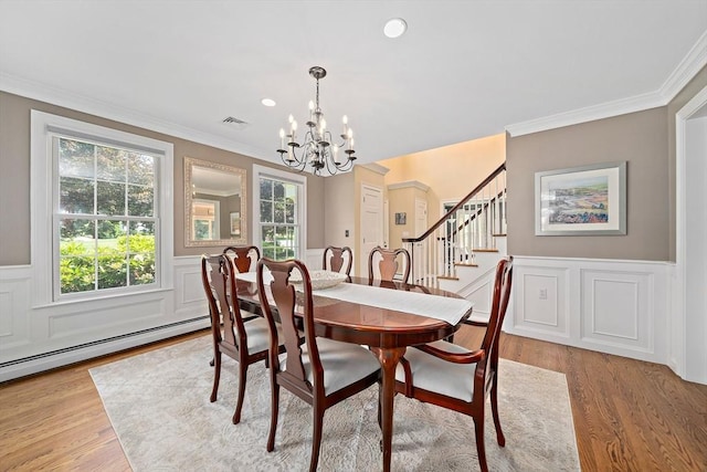 148 Old Schoolhouse Ln, Hanover, MA 02339 - dining area with a chandelier, stairway, a wainscoted wall, ornamental molding, and light wood-style flooring