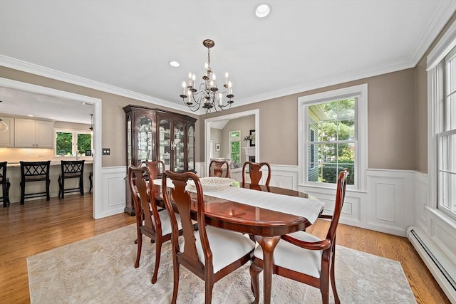 148 Old Schoolhouse Ln, Hanover, MA 02339 - dining space with baseboard heating, healthy amount of natural light, a wainscoted wall, a chandelier, and ornamental molding
