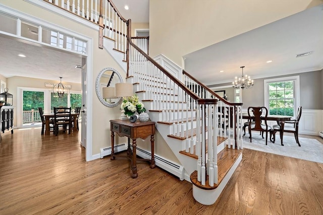 148 Old Schoolhouse Ln, Hanover, MA 02339 - stairway with a chandelier, wood finished floors, a baseboard radiator, crown molding, and recessed lighting