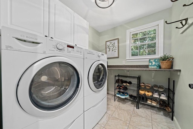 148 Old Schoolhouse Ln, Hanover, MA 02339 - washroom featuring washing machine and clothes dryer, cabinet space, and light tile patterned flooring