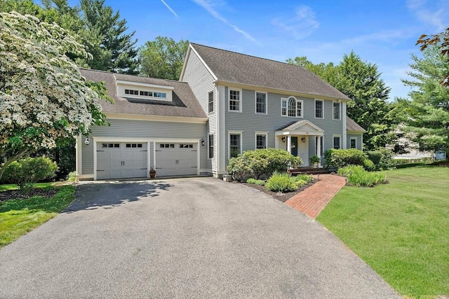 148 Old Schoolhouse Ln, Hanover, MA 02339 - colonial-style house with driveway, a front lawn, roof with shingles, and a garage