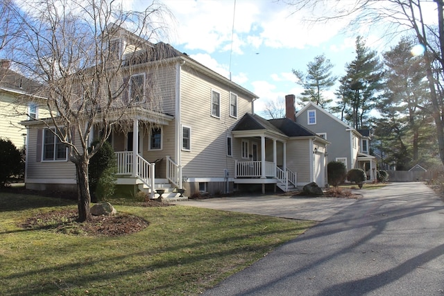 view of front of property with covered porch and a front yard