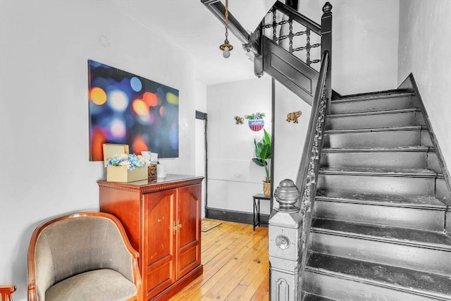 stairs featuring hardwood / wood-style flooring