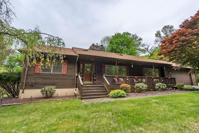 ranch-style house featuring a chimney, a front lawn, covered porch, and an attached garage