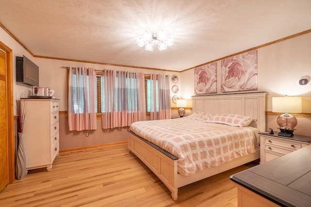 bedroom with crown molding, light wood-type flooring, and a chandelier