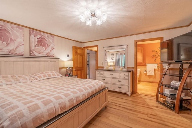 bedroom with light wood finished floors and ensuite bathroom