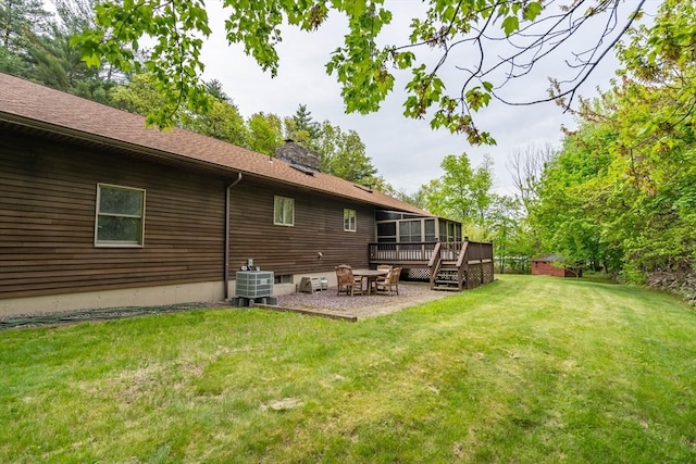 back of house featuring a sunroom, central AC unit, a chimney, a deck, and a patio