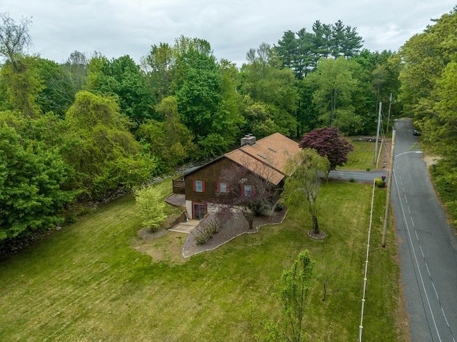 view of subject property featuring a heavily wooded area