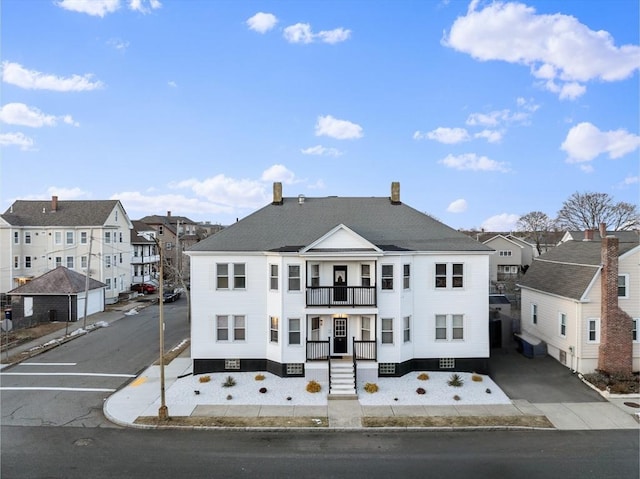 view of front of house featuring a residential view and a balcony