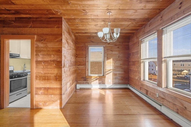 unfurnished dining area with a baseboard heating unit, wood ceiling, wood walls, and wood finished floors