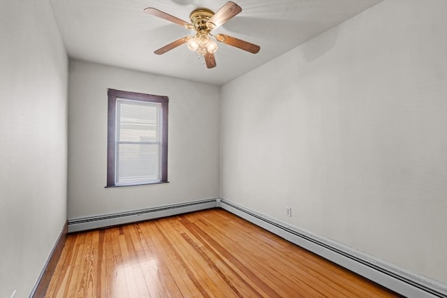 unfurnished room with a baseboard heating unit, light wood finished floors, and a ceiling fan