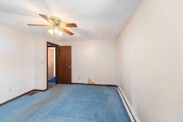 carpeted empty room with a baseboard heating unit, baseboards, and a ceiling fan