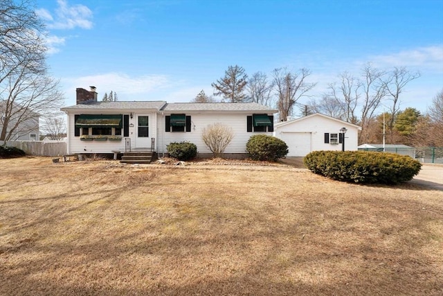 single story home featuring an outbuilding, a front lawn, a detached garage, fence, and a chimney