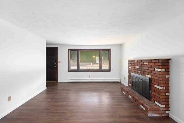 unfurnished living room featuring baseboards, baseboard heating, a fireplace, wood finished floors, and a textured ceiling